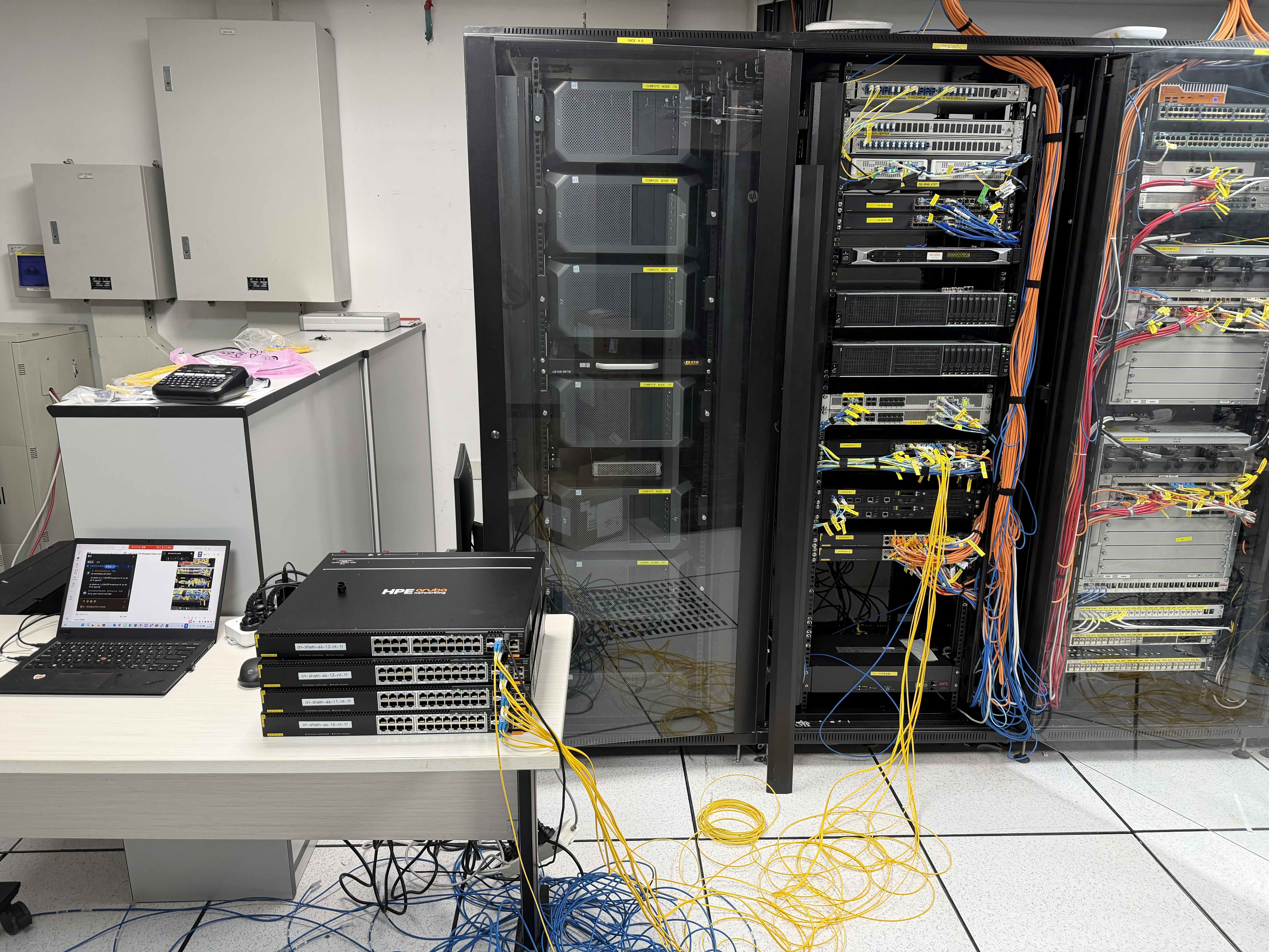 China field engineer working on rack cabling and network equipment